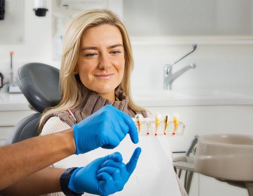 A dentist at Blockley Dental Partnership showing a patient the process of the root canal treatment.